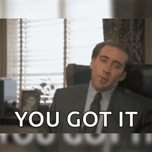 A Man In A Suit And Tie Smoking A Cigarette With The Words You Got It Behind Him GIF