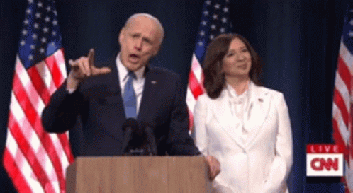 Man At Podium With Woman In White GIF
