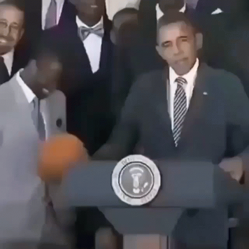 A Man In A Suit And Tie Stands Behind A Podium With The Seal Of The President Of The United States GIF