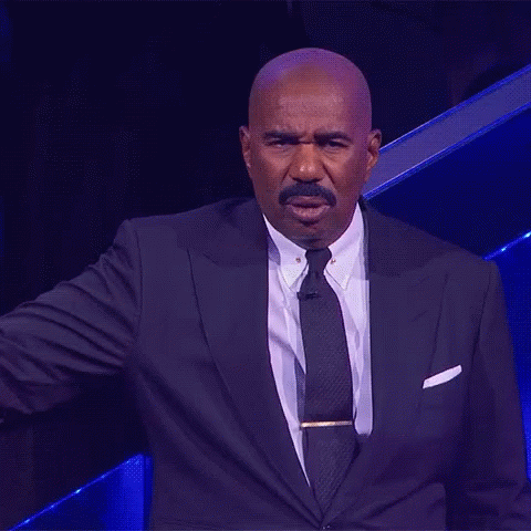 A Man In A Suit And Tie Stands In Front Of A Blue Background GIF