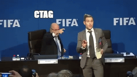 A Man In A Suit And Tie Stands In Front Of A Blue Wall That Says Fifa GIF