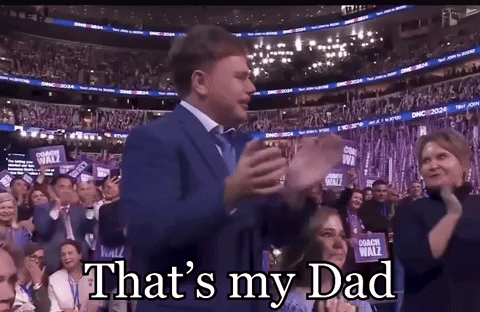 A Man In A Suit And Tie Stands In Front Of A Crowd And Says " That 'S My Dad " GIF
