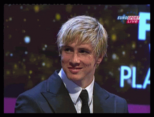 A Man In A Suit And Tie Stands In Front Of A Eurosport Live Sign GIF