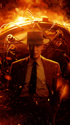 A Man In A Suit And Tie Stands In Front Of A Glowing Sphere GIF
