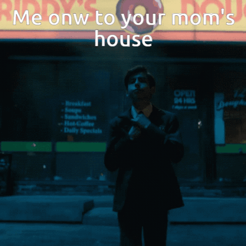 A Man In A Suit And Tie Stands In Front Of A Mcdonald 'S Sign GIF