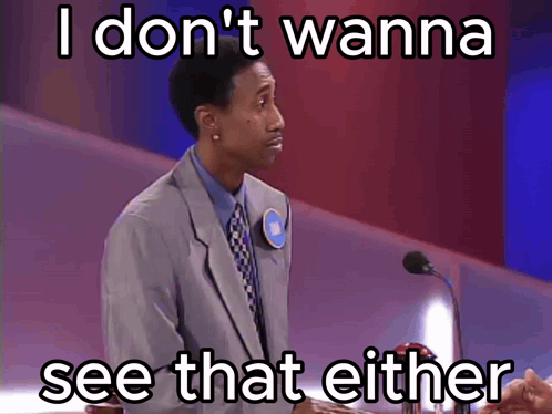 A Man In A Suit And Tie Stands In Front Of A Microphone With The Words I Don T Wanna See That Either Below Him GIF