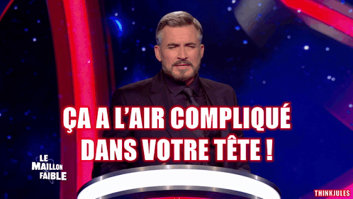 A Man In A Suit And Tie Stands In Front Of A Podium With The Words Ca A L' Air Complique Dans Votre Tete GIF