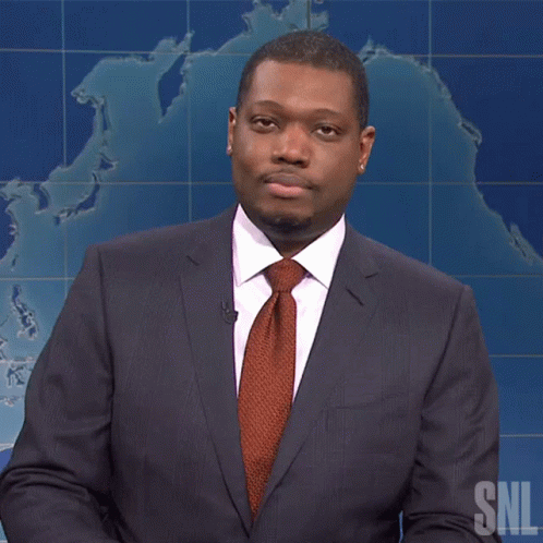 A Man In A Suit And Tie Stands In Front Of A Snl Map GIF