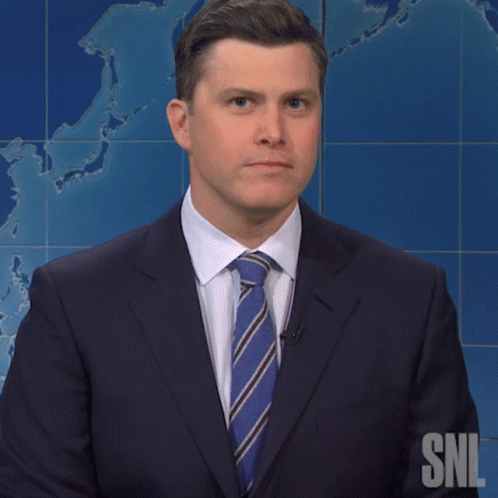 A Man In A Suit And Tie Stands In Front Of A Snl Map GIF