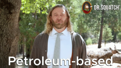 a man in a suit and tie stands in front of a tree with the words petroleum-based on the bottom