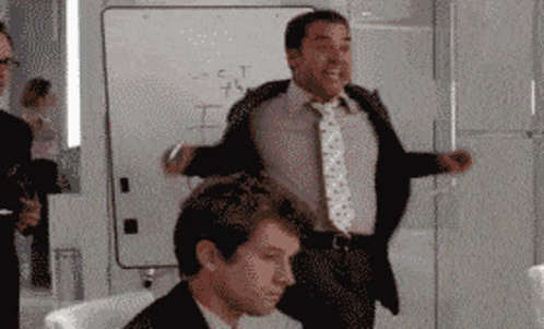 A Man In A Suit And Tie Stands In Front Of A White Board That Says " S = C = T " On It GIF