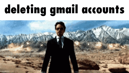 A Man In A Suit And Tie Stands In Front Of Mountains With The Words " Deleting Gmail Accounts " Above Him GIF