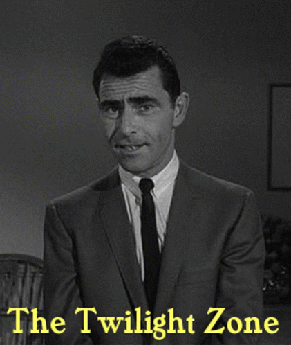 A Man In A Suit And Tie Stands In Front Of The Twilight Zone GIF