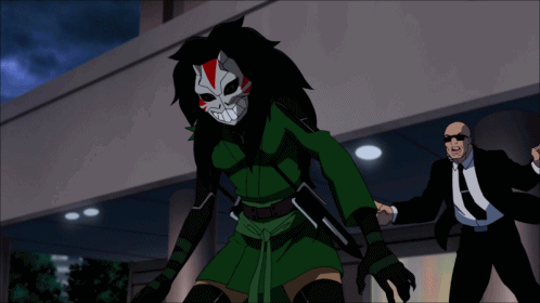 A Man In A Suit And Tie Stands Next To A Cartoon Character In A Mask GIF