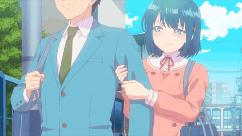 a man in a suit and tie stands next to a girl in a pink coat