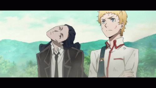 A Man In A Suit And Tie Stands Next To A Man In A White Shirt GIF