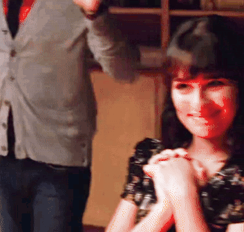 A Man In A Suit And Tie Stands Next To A Woman In A Black Dress GIF