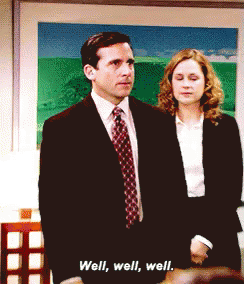 A Man In A Suit And Tie Stands Next To A Woman In A White Shirt And Says Well Well Well GIF