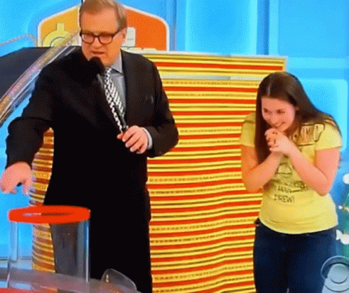 A Man In A Suit And Tie Stands Next To A Woman In A Yellow Shirt That Says Brew GIF
