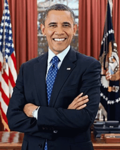 A Man In A Suit And Tie Stands With His Arms Crossed In Front Of An American Flag GIF