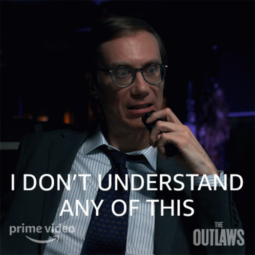 A Man In A Suit And Tie Talking On A Phone With The Words " I Don 'T Understand Any Of This " Behind Him GIF