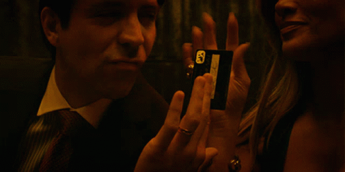 A Man In A Suit And Tie Talks To A Woman GIF