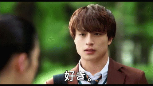 A Man In A Suit And Tie Talks To A Woman In A Park GIF