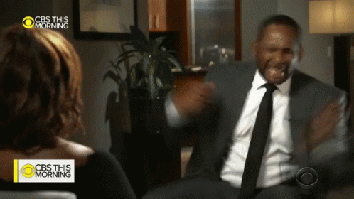 A Man In A Suit And Tie Talks To A Woman On Cbs This Morning GIF