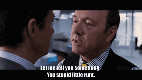 A Man In A Suit And Tie Talks To Another Man With The Words Let Me Tell You Something You Stupid Little Runt GIF
