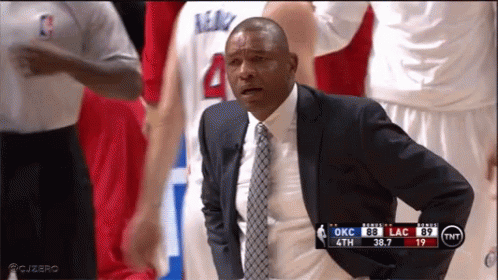 A Man In A Suit And Tie Watches A Basketball Game GIF