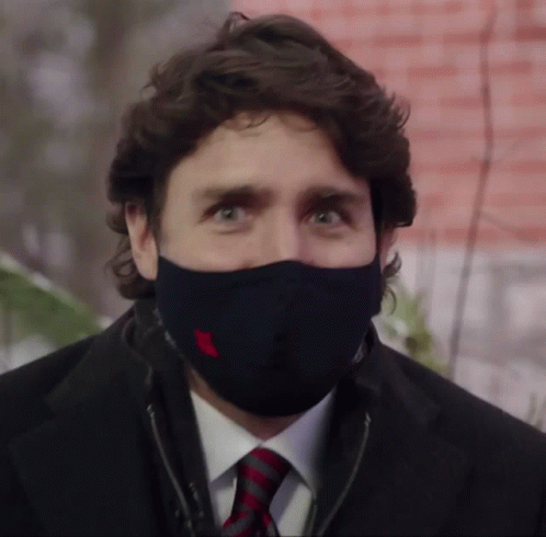 A Man In A Suit And Tie Wearing A Black Mask GIF