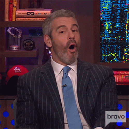 Man In Suit And Tie With Bravo Logo GIF