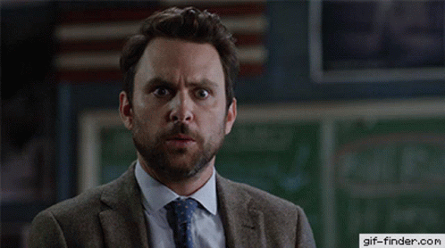 A Man In A Suit And Tie With A Gif-Finder.com Logo On The Bottom GIF