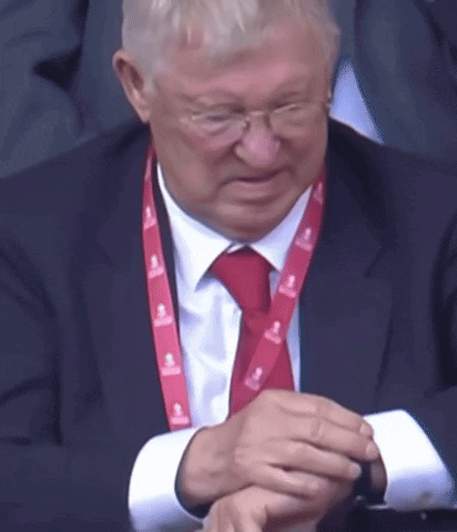 A Man In A Suit And Tie With A Lanyard That Says Emirates GIF