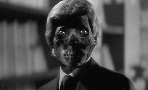 A Man In A Suit And Tie With A Skeleton Mask On His Face . GIF