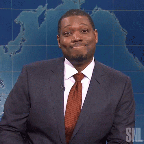 A Man In A Suit And Tie With A Snl Logo On The Bottom GIF