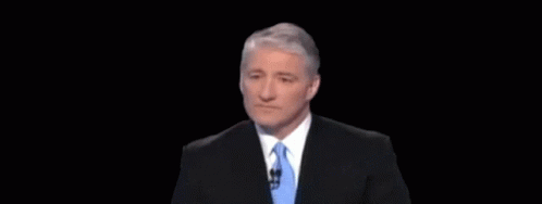 A Man In A Suit And Tie With An Optical Illusion Behind Him GIF