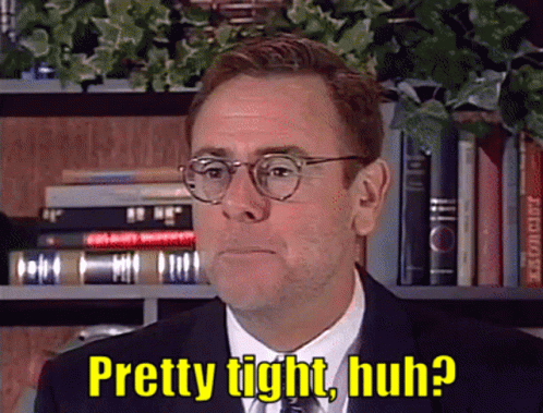 A Man In A Suit And Tie With Glasses Says Pretty Tight Huh GIF