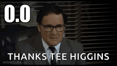 a man in a suit and tie with glasses says thanks tee higgins