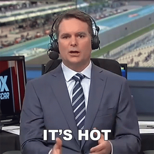 A Man In A Suit And Tie With Headphones Says It 'S Hot GIF