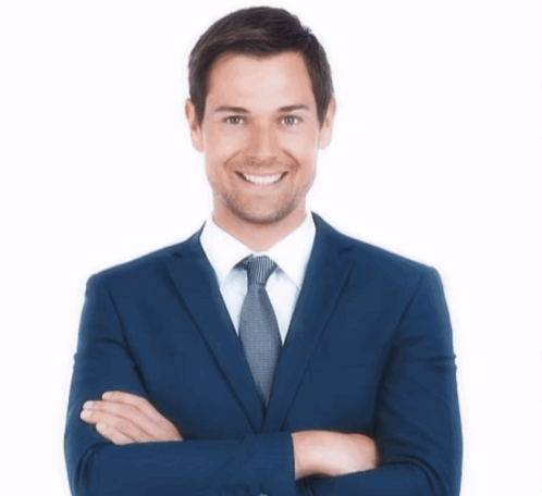 A Man In A Suit And Tie With His Arms Crossed Is Smiling GIF