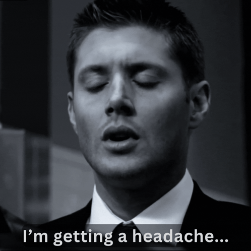 A Man In A Suit And Tie With His Eyes Closed Says " I 'M Getting A Headache " GIF