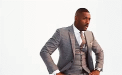 A Man In A Suit And Tie With His Hands On His Hips . GIF