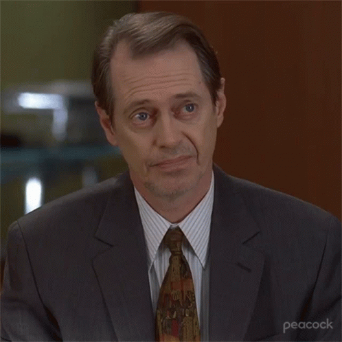 A Man In A Suit And Tie With Peacock Written On The Bottom Right GIF