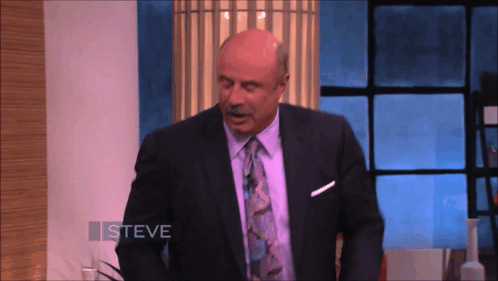 A Man In A Suit And Tie With The Name Steve On The Bottom GIF