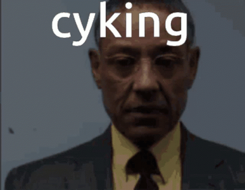 A Man In A Suit And Tie With The Word Cyking On His Face GIF