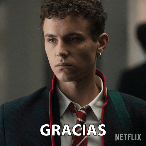 A Man In A Suit And Tie With The Word Gracias Written Below Him GIF