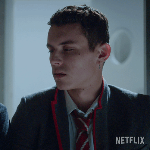 A Man In A Suit And Tie With The Word Netflix On The Bottom GIF