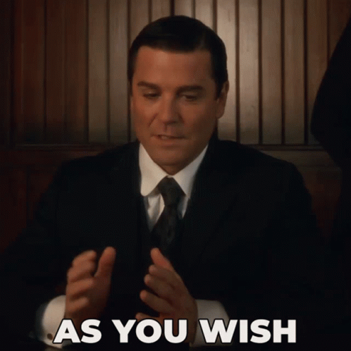 A Man In A Suit And Tie With The Words As You Wish Above Him GIF