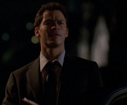 A Man In A Suit And Tie With The Words Go With God On The Bottom GIF